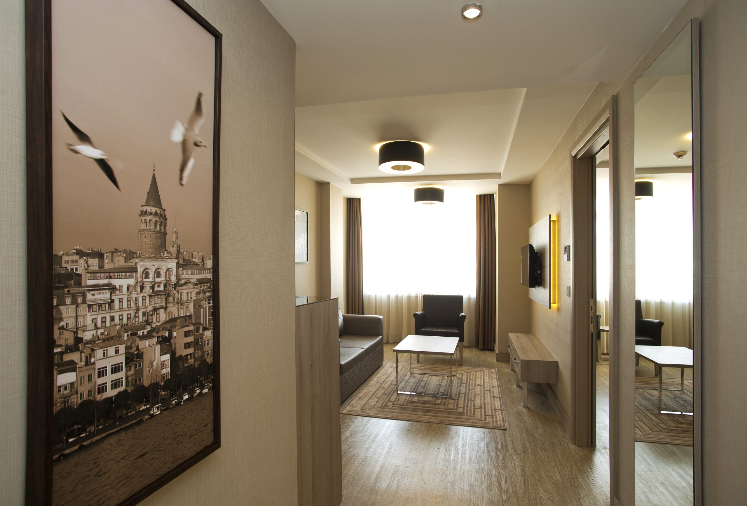 Family Suite: view from the entrance into the living room, a Galata Tower picture on the wall